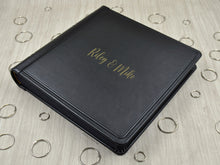 Carica l'immagine nel visualizzatore di Gallery, example of matte gold vinyl personalization on a black leather cover of a photo album by Giovelli Design