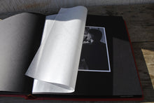 Load image into Gallery viewer, opened album with black pages and protective tissue
