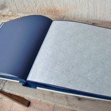 Load image into Gallery viewer, opened album with blue pages and protective tissue by Giovelli Design
