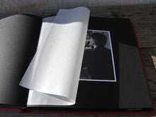 Load image into Gallery viewer, opened album with black pages and protective tissue

