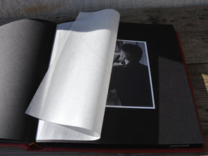 opened album with black pages and protective tissue